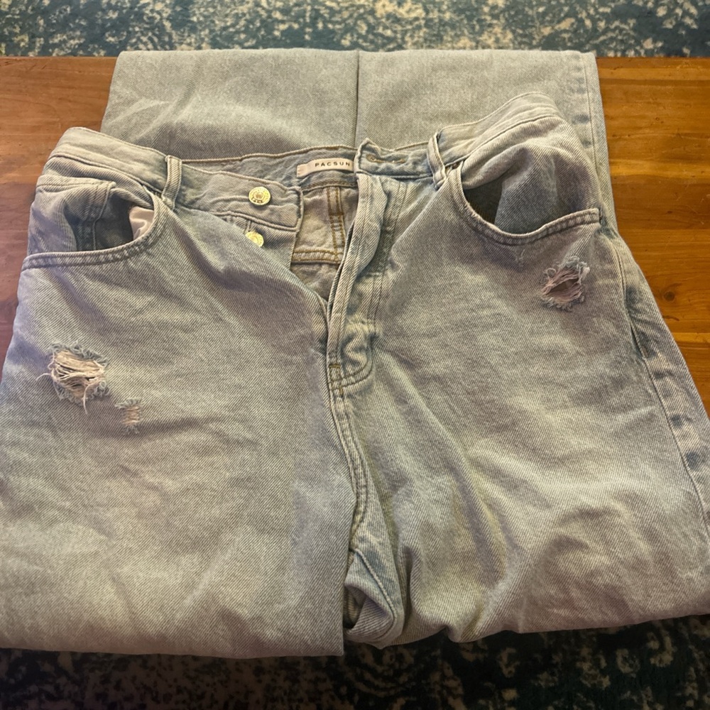 Blue denim jeans with rips on knees